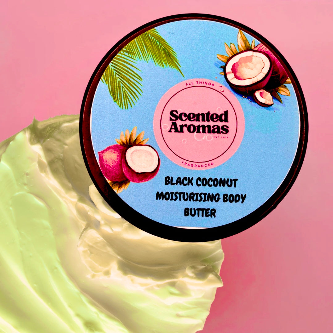 A jar of The Soap Gal x Black Coconut Body Moisturising Butter 100ml against a pink background, with swirled body butter beside it. This skin moisturiser delivers a luxurious summer fragrance that leaves your skin feeling silky smooth and beautifully nourished.