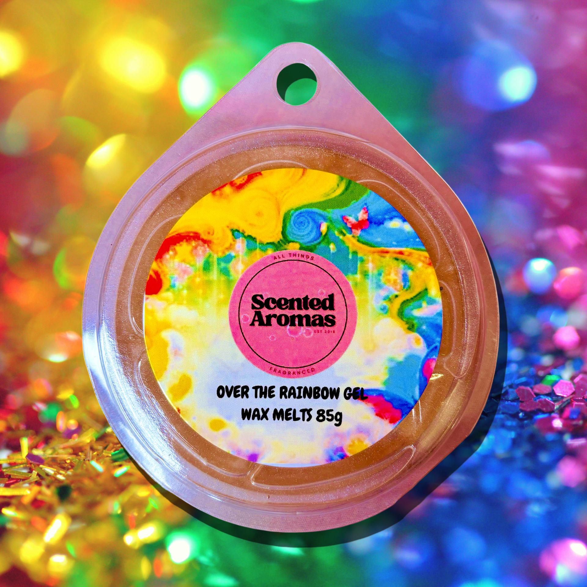 The vibrant packaging of The Soap Gal x's "Over The Rainbow Gel Wax Melt" 85g promises a long-lasting fragrance, set against a glittery background.