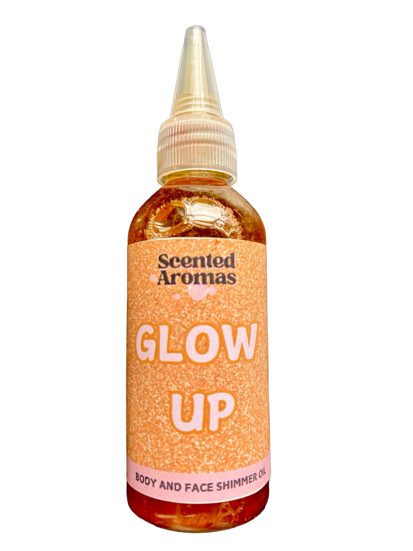 The "Glow Rituals" Shimmering Body Oil (100ml) by Scented Aromas features a gold-hued liquid and pointed nozzle for easy application, enhancing your skincare routine with a bronzed glow for face and body.