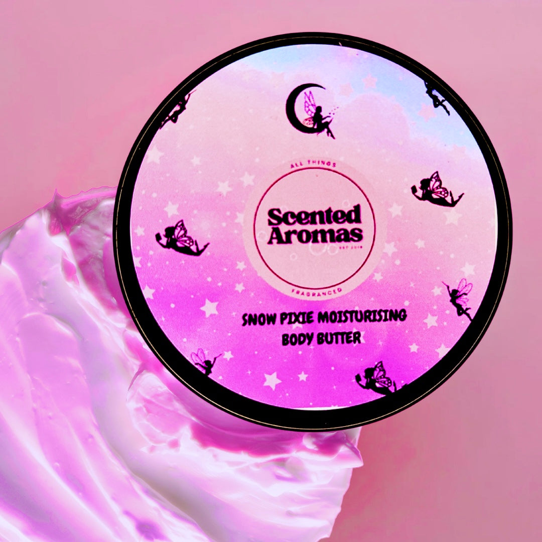 A container of The Soap Gal x's Snow Pixie Body Moisturising Butter 100ml, decorated with delicate fairy silhouettes and a starry motif, rests elegantly on a pink backdrop alongside its pink cream. Delight in the sweet aroma of this vegan body butter as it nurtures your skin.