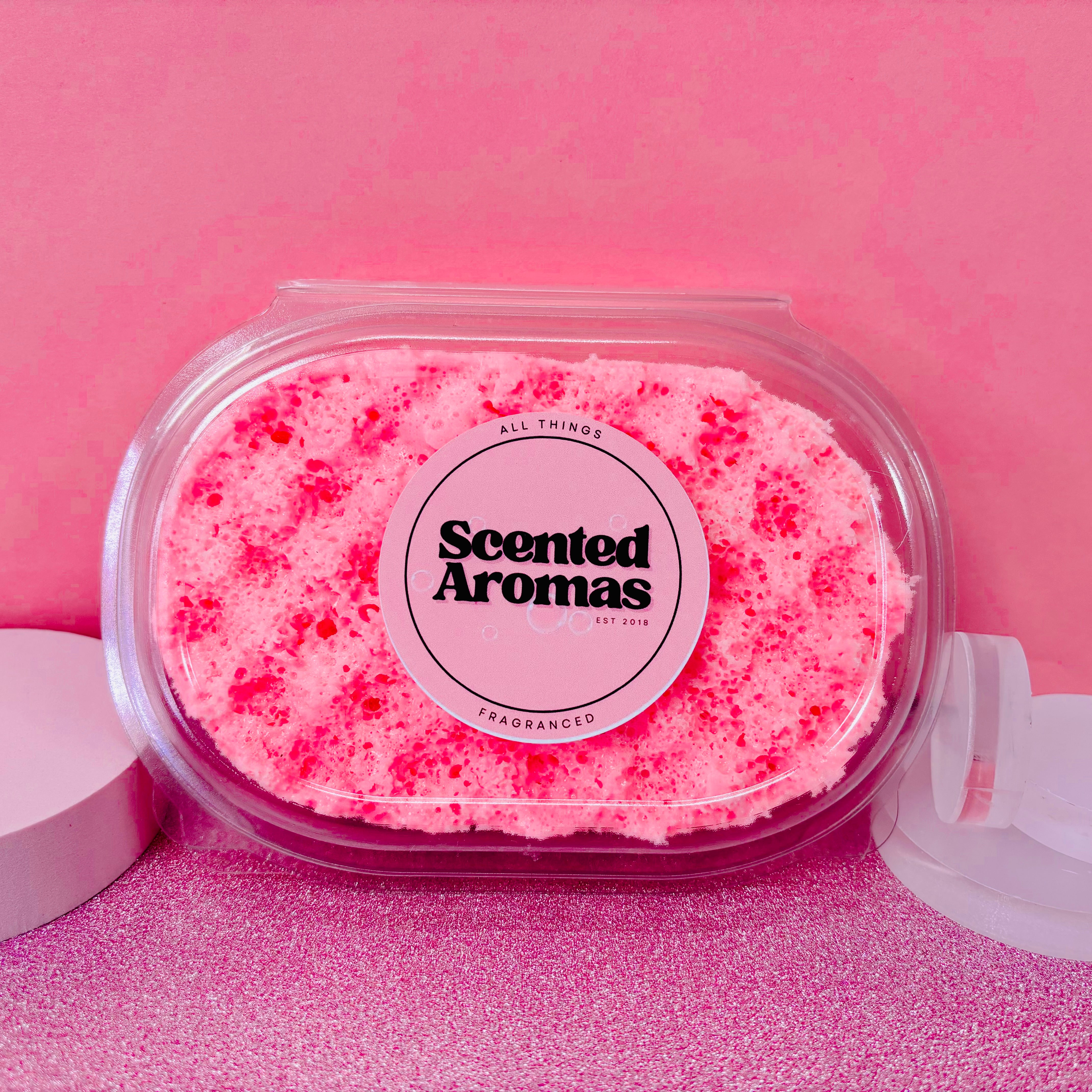 The "Valentines Gift Set Bundle" by Scented Aromas, featuring a pink scented soap in a clear container against a pink background, embodies pamper nights. Pair it with the Birthday Cake Bath Bomb for an indulgent and relaxing experience.