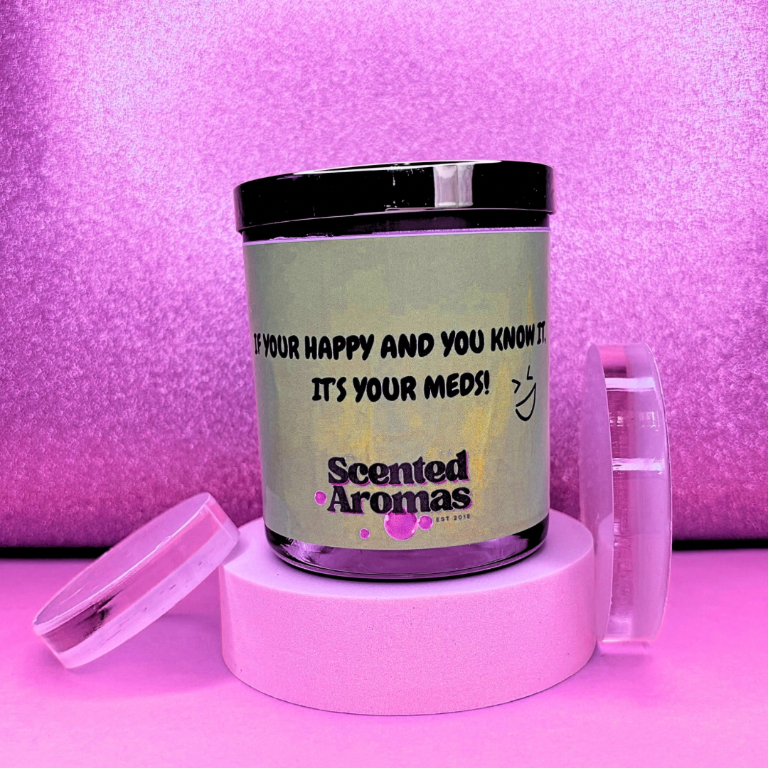 A pink background highlights The Soap Gal x's "If You Are Happy and You Know It Positive Affirmation Quote Candle" (200g), featuring the cheerful phrase "IF YOU'RE HAPPY AND YOU KNOW IT, IT'S YOUR MEDS!" This soy wax candle combines humor with empowerment, making it an ideal choice for uplifting any mood.