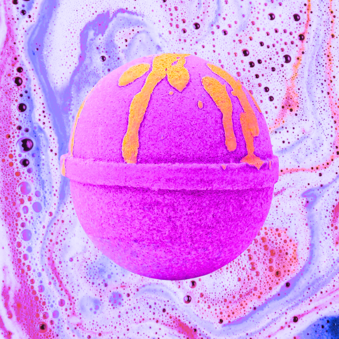 A vibrant purple Aliens Bath Bomb by Scented Aromas, with yellow accents, reminiscent of the iconic fragrance, set against a colorful, bubbly backdrop.