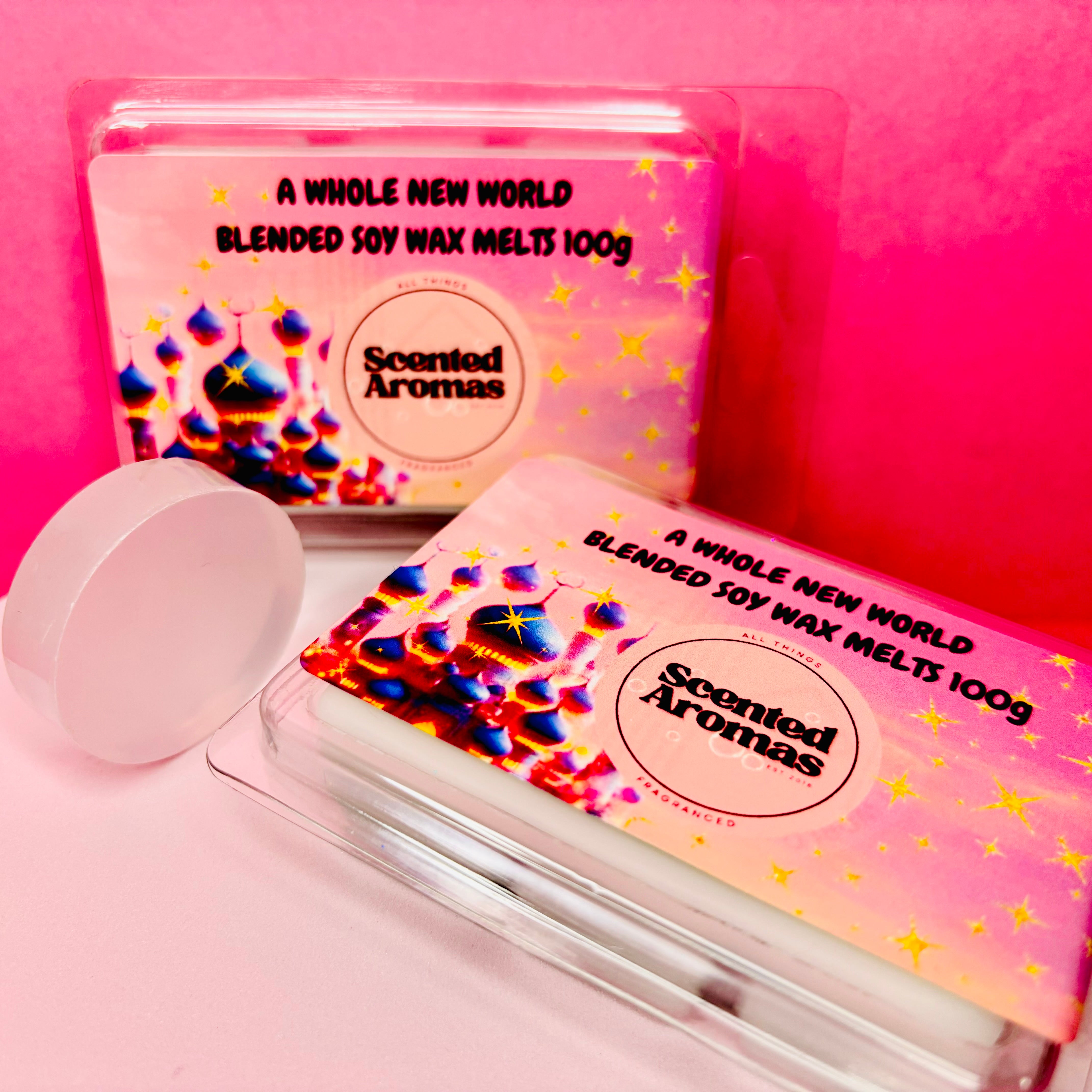 Two packages of "A Brand New World" soy wax melts by The Soap Gal x are elegantly displayed against a pink background.