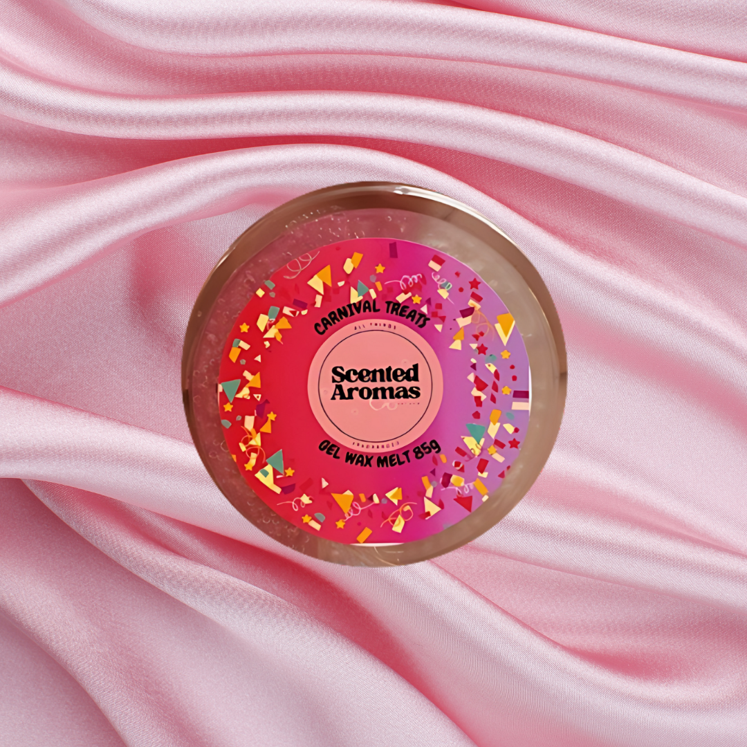 A round pink scented gel wax melt from The Soap Gal x, named "Carnival Treats Gel Wax Melts 85g," rests on a pink satin fabric backdrop, releasing an enticing popcorn fragrance reminiscent of beloved fairgrounds.