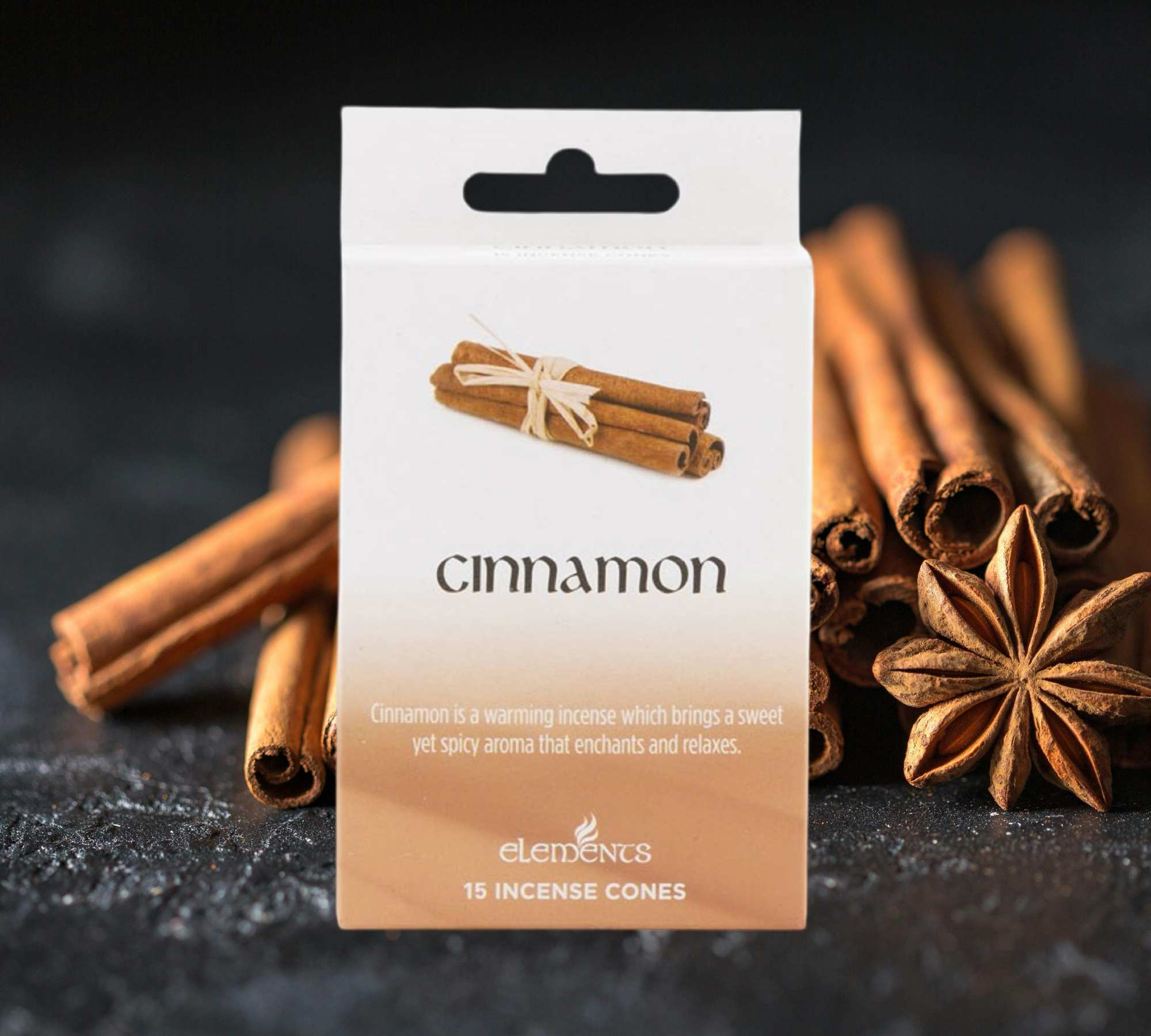 A box of Cinnamon Incense Cones by Scented Aromas is artfully positioned with cinnamon sticks and star anise, crafting a serene ambiance that enhances the soothing benefits of this aromatic blend.