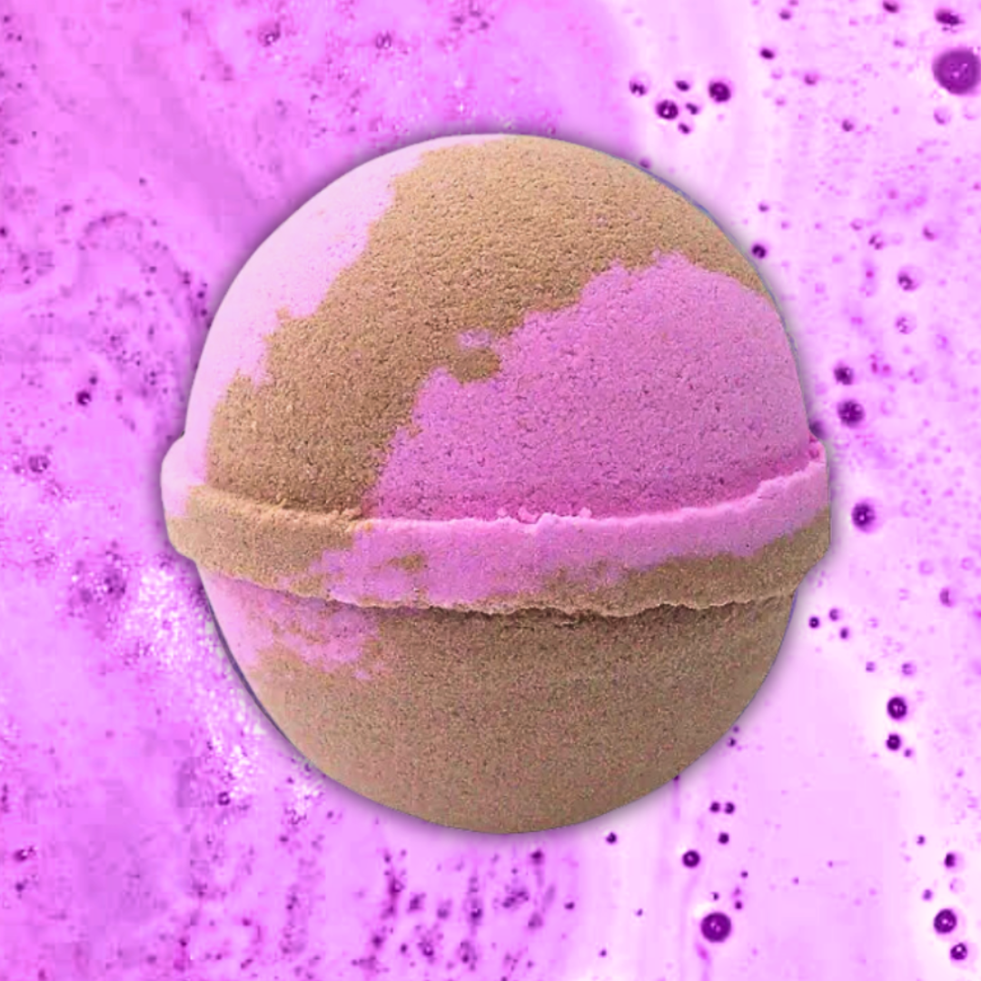 A Girl Power Positivity Bath Bomb from The Soap Gal x fizzing and dissolving in water, creating a swirl of vibrant pink and purple foam.