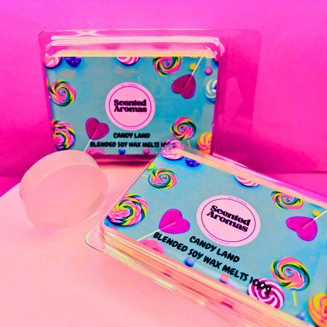 Two packs of "Candy Kingdom Wax Melts 85g" by The Soap Gal x, adorned with vibrant candy-themed packaging on a pink background, offer a delightful sweet fragrance using their soy wax blend.