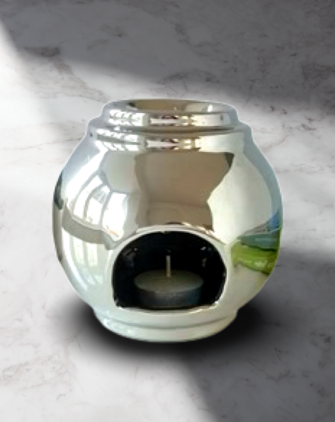 The Silver Dish Stackable Wax Melt Warmer by The Soap Gal x is a shiny, silver ceramic piece with a round shape that elegantly enhances any marbled surface, making it ideal for stylish homes looking for minimalist oil burners.