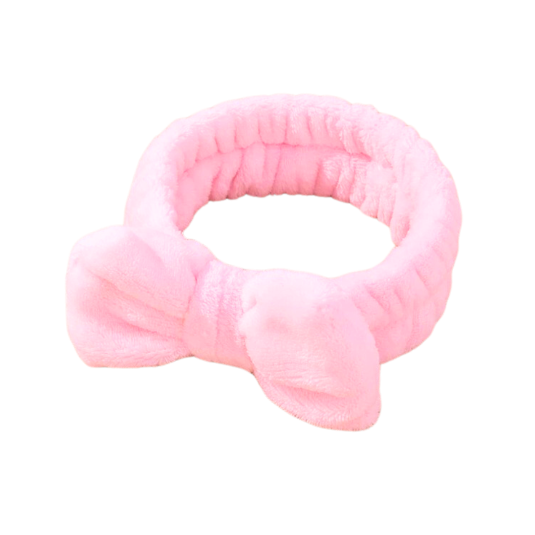 Introducing the Barbie Pink Makeup Headband with Bow by The Soap Gal x, featuring a soft pink texture and a cute bow on the front.